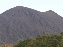 Wide shot of deeply eroded side of volcano with valleys and ravines, Japan Stock Footage
