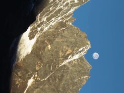 Panning shot of Time-lapse of the moon passing by Himalayan peaks at sunrise. Stock Footage