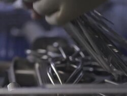 African American nurse picking up surgical tools in an operating room Stock Footage