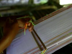 C/U hands weaving coloured thread on small artisanal loom Stock Footage