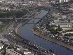 Aerial View of SÃƒÂ£o Paulo 'Marginal TietÃƒÂª' and river with heavy traffic Stock Footage