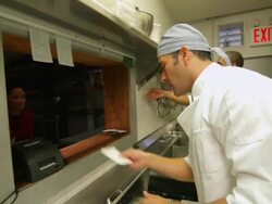 Chefs preparing food in busy kitchen Stock Footage