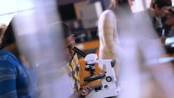 Two students share a microscope, male student peers inside mircorscope Stock Footage