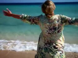 Woman spinning on beach Stock Footage
