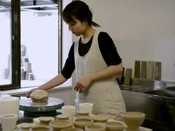 MS Shot of Potter woman is using digital tablet in studio / Kyoto, Japan Stock Footage