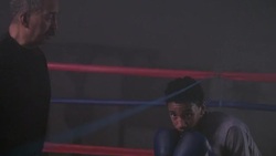 A coach guides his boxer through agility training as the boxer bobs and weaves under a rope. Stock Footage