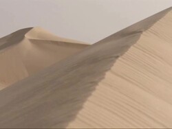 Medium Long Shot, crane tracking-left - Sand dunes form unique shapes in the Sahara Desert in Egypt Stock Footage