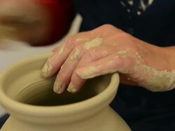 CU Shot of female potter finishing shaping pitcher on potterwheel at pottery / Landshut, Bavaria, Germany Stock Footage