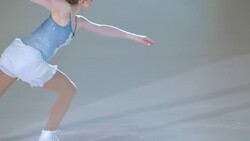 SLO MO TS Female figure skater performing a jump Stock Footage