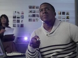 Young man in creative space using laser pointer during slide show as co-worker takes notes Stock Footage