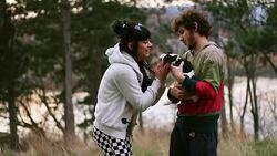 Young couple playing with the puppy in woods Stock Footage