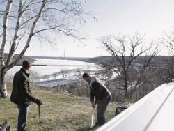 MS Two young men hitting golf balls on ridge with their truck behind them / Stillwater, Minnesota, United States Stock Footage