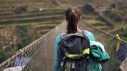 Hiker girl crossing the bridge Stock Footage