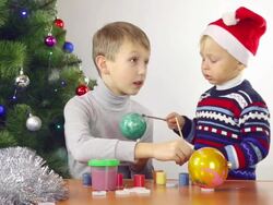 children paint the Christmas toys Stock Footage