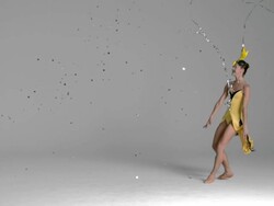 slow motion of Ballerina jumping through silver confetti floating down around her Stock Footage
