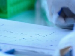 Scientist writing notebook in laboratory Stock Footage