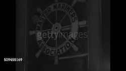 1936: NEW ENGLAND: FISHING INDUSTRY: Master Mariners Association sign, men entering building. INT room w/ fishermen playing cards, poll, relaxing, smoking pipes. Instructional Video