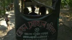 A young boy and his Grandfather in rural Bangladesh return home via electric taxi after receiving treatment from a healthcare NGO Stock Footage