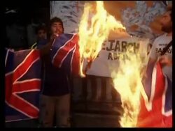 Night protest outside the British embassy,  UK flag being burnt News Clip