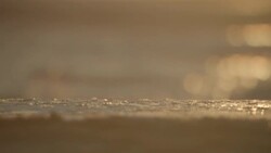 SLOW MOTION CLOSE UP water on beach at sunrise Stock Footage