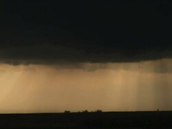 WS View of dark storm clouds churning around and developing tornado with orange sunrays / Texas, United States Stock Footage