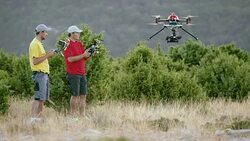 LD Two operators lifting drone into air Stock Footage