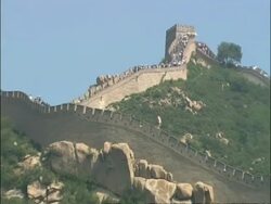Zoom in from battlement to Great Wall of China crowded with tourists, Badaling, China Stock Footage