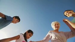 Multi-generation family holding hands circling over camera Stock Footage