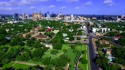 Aerial Over Austin Texas East side with Texas Flag fly by Skyline Cityscape in the background with Texas State Capitol Stock Footage