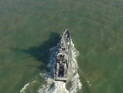 WS AERIAL DS ZO Shot over customs petrol craft moving ahead / Suffolk, France Stock Footage