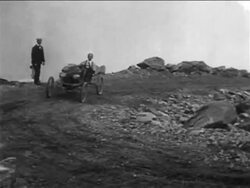 B/W 1905 race car coming around corner in car race on Pike's Peak / documentary Stock Footage