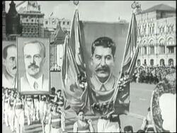 A May Day crowd marches through Red Square with banners and large posters of Joseph Stalin and Vyacheslav Molotov. News Clip
