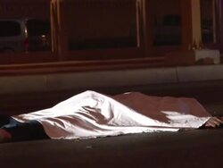 MS Shot of Mexican medics putting cloth over dead gun shot victim on streets AUDIO / Ciudad Juarez, Juarez, Mexico Stock Footage