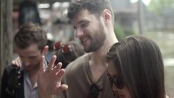 Group of friends look at and try on antique rings in Texas ghost town Stock Footage