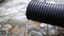 Industrial pipe polluting the natural water resources Stock Footage