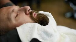 Close-up of beautiful attractive adult man with beard in a barber shop Stock Footage