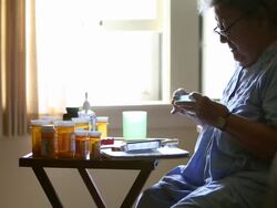 MS Elderly woman preparing to put prescription medication in pill box / Minneapolis, Minnesota, United States Stock Footage