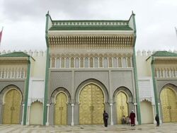 MS Shot of incredibly ornate exterior doors of Royal Palace and family seen viewing building and posing for photographs / Fez, Fes-Boulemane, Morocco Stock Footage