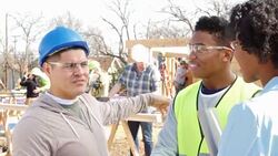 Construction foreman updates charity staff member on progress of home being built for charity Stock Footage
