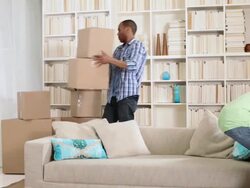 Couple moving boxes and sitting on sofa Stock Footage