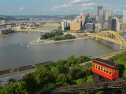 WS View of Pittsburgh Pennsylvania from Mt Washington hill looking at Golden Triangle and city skyscrapers where the three rivers and red incline cars coming up mountain / Pittsburgh, Pennsylvania, United States Stock Footage