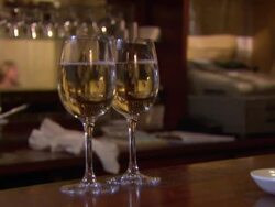 Two Glasses of White White Being Poured by Barman News Clip