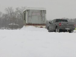 WS View of ice fishing house and pickup truck lodged in snow during winter / Minneapolis, Minnesota, USA Stock Footage