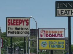 Retail stores street signs and traffic Stock Footage