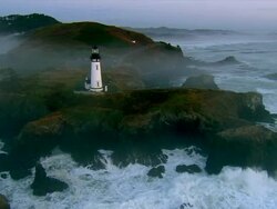 AERIAL Lighthouse at Pacific coast at sunset, Oregon, USA Stock Footage