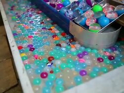 CU Shot of bouncy balls in water tank of stall, bouncy ball scooping at summer festival / Toshima, Tokyo, Japan Stock Footage