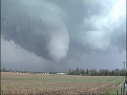 WA Large swirling tornado growing over horizon of rural buildings, USA Stock Footage