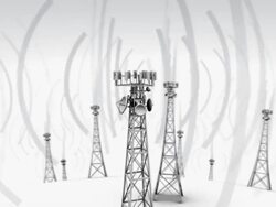 Camera circles around the top of a cell tower emitting waves, with other cell towers in the background Stock Footage