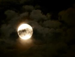TIMELAPSE: Full moon among clouds Stock Footage