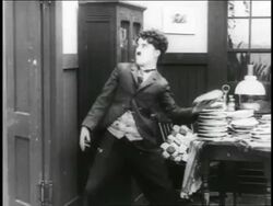 B/W 1916 man (Charlie Chaplin) throwing pie / short Stock Footage